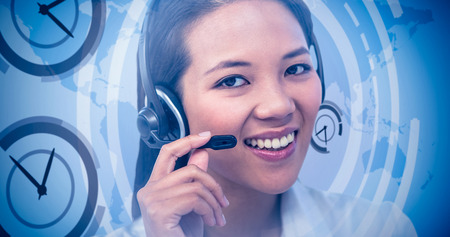 Smiling businesswoman using headset against international business interface