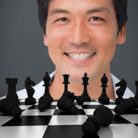 Smiling young man against grey backgroundの写真素材