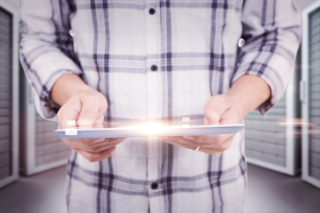 Casual man using tablet pc against server roomの写真素材