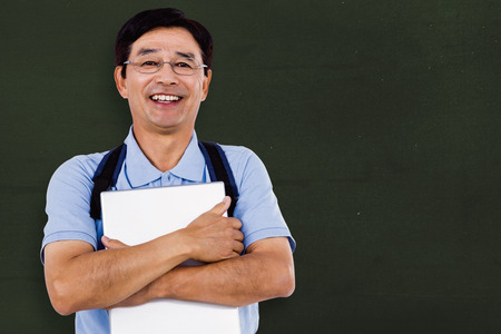 Portrait of cheerful man holding documents against greenの写真素材
