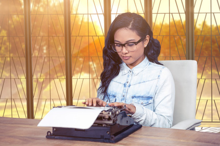 Young thoughtful businessman with arms crossed standing in creative office