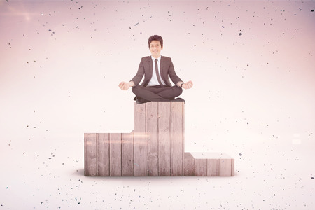 Smiling asian businesswoman pointing against grey backgroundの写真素材