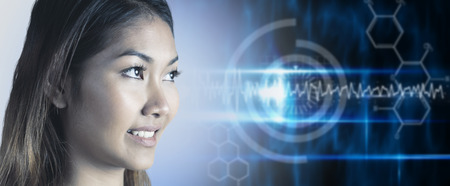 Smiling businesswoman looking away against blue technology design with circle