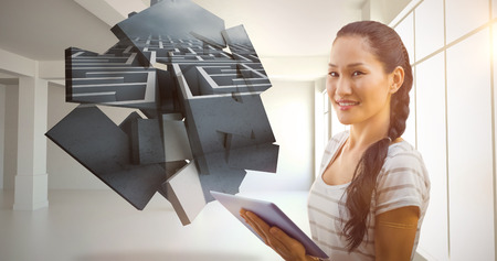 Businesswoman using tablet in the office against maze graphic on abstract screen in roomの写真素材