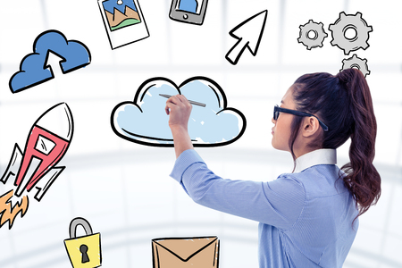 Businesswoman holding disposable cup and looking at wall with notes against cloud computing doodleの写真素材