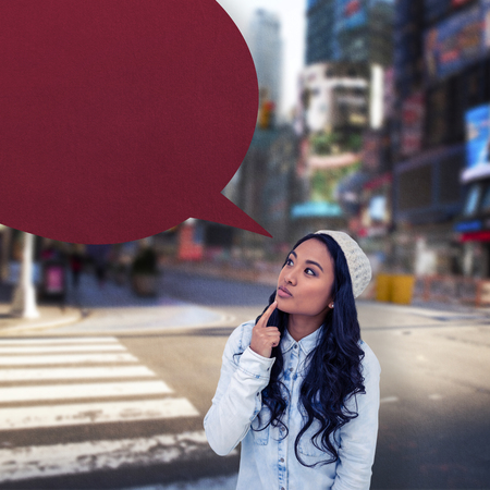 Asian woman with finger on chin against blurry new york street