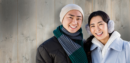 Portrait of adorable couple against wooden planksの写真素材
