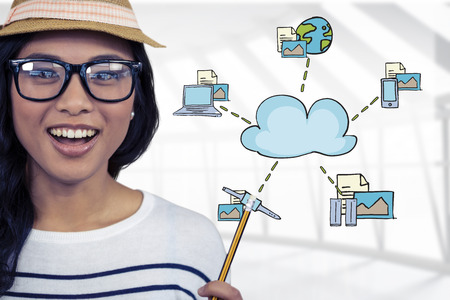 Attractive Asian woman with hat holding pencil against spacious roomの写真素材