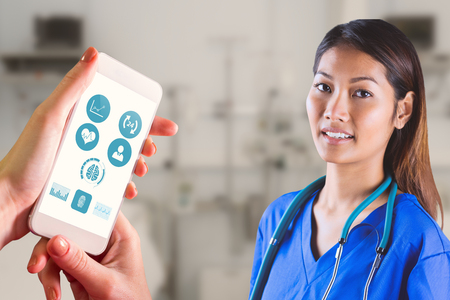 Asian nurse with stethoscope looking at the camera against sterile bedroom