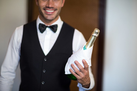 Handsome barman serving champagne in restaurantの写真素材