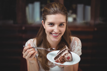 Portrait of smiling woman with desert in restaurantの写真素材