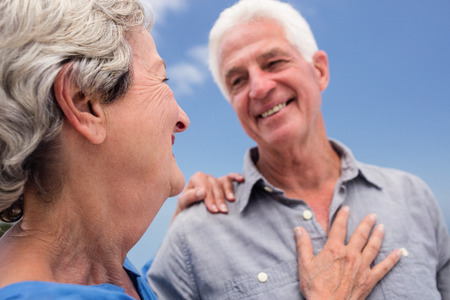Senior couple embracing each other on the beach on a sunny dayの写真素材