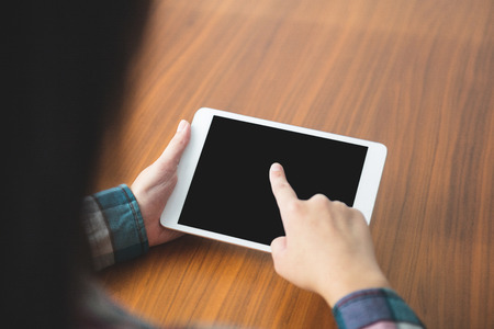 Woman using a digital tablet at home