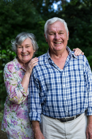 Portrait of cheerful senior couple standing in back yardの写真素材