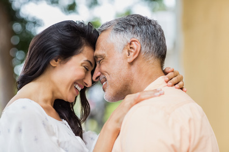 Happy woman embracing man with city
