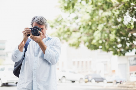 Front view of man looking into camera in city