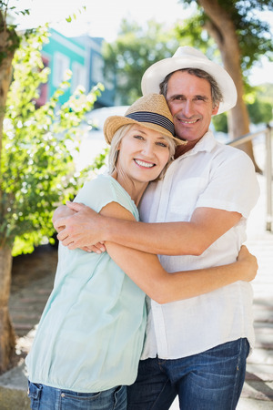 Portrait of smiling couple embracing in parkの写真素材