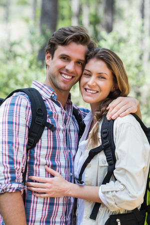 Portrait of happy couple standing in forestの写真素材