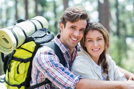 Portrait of young smiling couple relaxing in forestの写真素材