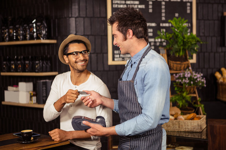 Man paying his coffee in a coffee shop