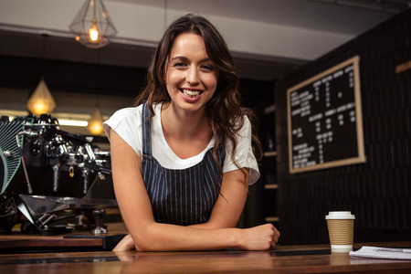 Portrait of smiling barista at coffee shopの写真素材