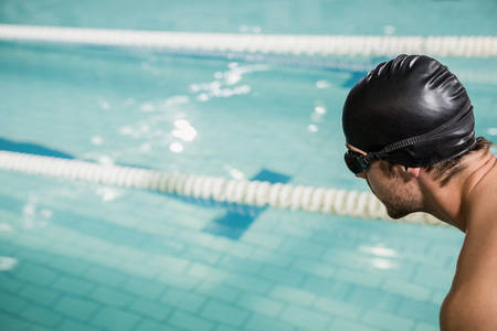 Swimmer about to dive into the pool at leisure centerの写真素材