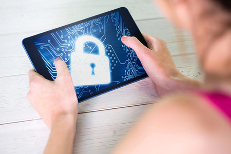 Woman holding a laptop with a lock on itの写真素材