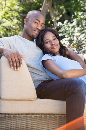 Portrait of young couple relaxing on the sofa in the parkの写真素材