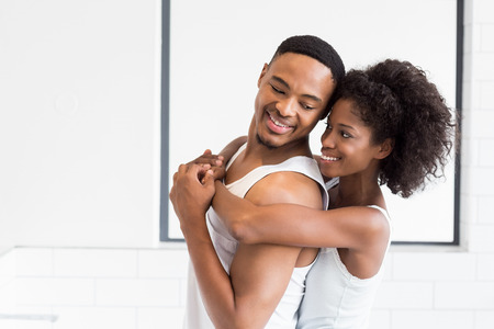 Young couple embracing each other in bathroom at home