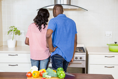 Young couple cooking food in the kitchenの写真素材
