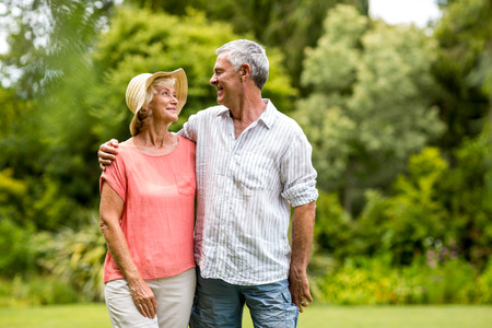 Smiling senior couple standing in yardの写真素材