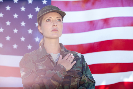 Soldier taking pledge in front of american flagの写真素材
