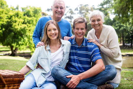 Portrait of happy family having a picnic in  park on a sunny day