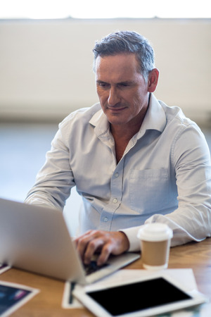 Businessman working at his desk in the officeの写真素材