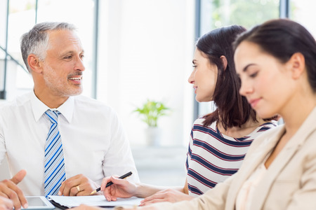 Businesspeople discussing at desk in the officeの写真素材
