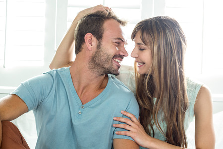 Close-up of happy couple on bed at home