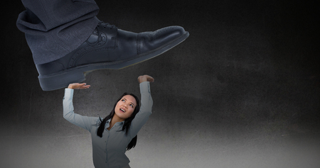 Businessman about to step on banana peel against black wallの写真素材