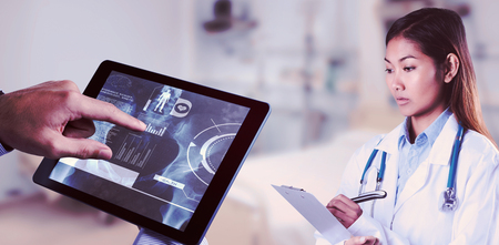 Asian doctor writing on files against sterile bedroomの写真素材