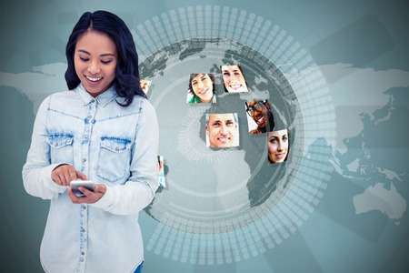 Asian woman using smartphone against holographic earth with picturesの写真素材