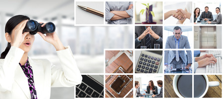A group of architects discussing a construction plan against windows overlooking cityの写真素材