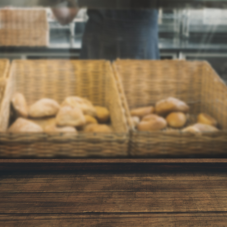High angle view of wooden flooring against smiling waiter in apron choosing breadの写真素材