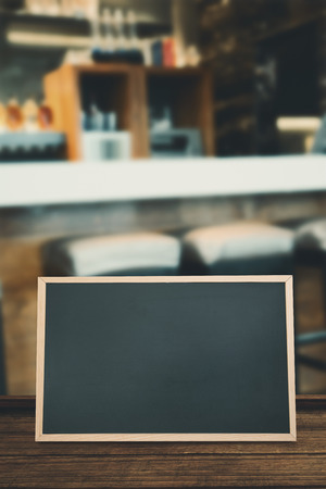 Square bar stools at the counter against chalkboardの写真素材