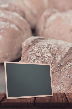 chalkboard    against close up of fresh loaf of breadの写真素材