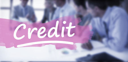 Business team having a meeting against word credit underlinedの写真素材
