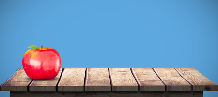 Red apple against blue backgroundの写真素材