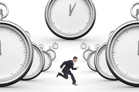 Geeky young businessman running mid air on a white background with clocksの写真素材