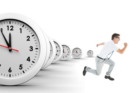 Geeky businessman running mid air on a white background with clocksの写真素材