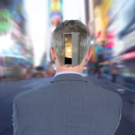 Rear view of businessman against blurry new york streetの写真素材