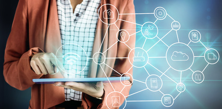 Businesswoman using a tablet against smartphone apps icons