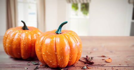 Pumpkin ornaments on desk against sitting roomの写真素材